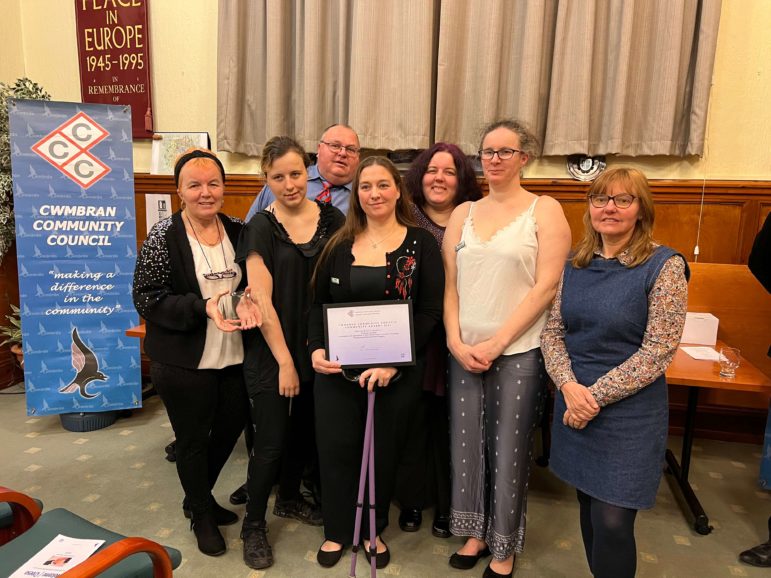 a group of people are presented with a certificate