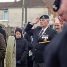 A veteran saluted at a memorial service