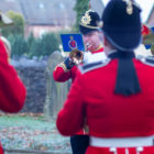 an army band. A man plays the trumpet