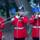 three members of an army band with brass instruments