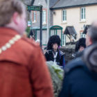 a piper watches a memorial service