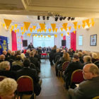 a roomful of people in a community meeting room