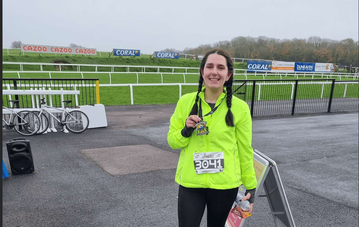 woman holding a medal