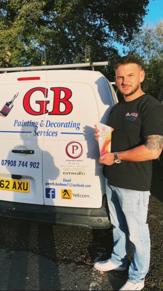 a man hold an award stood by a van