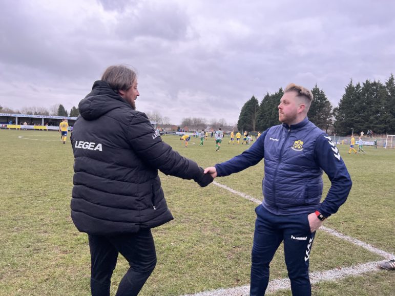 two football coaches shake hands