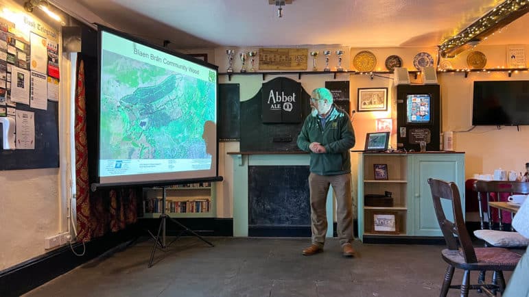 a man gives presentation in pub