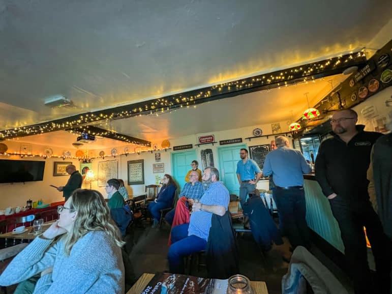 people sat in the bar of a pub