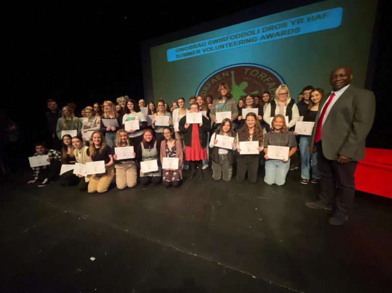 a group of young people holding certificates