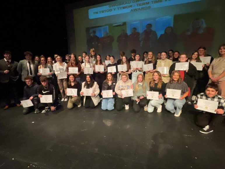a group of young people holding certificates
