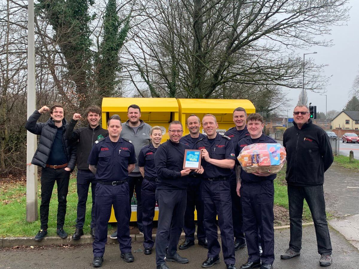 a group of fire fighters collect and award