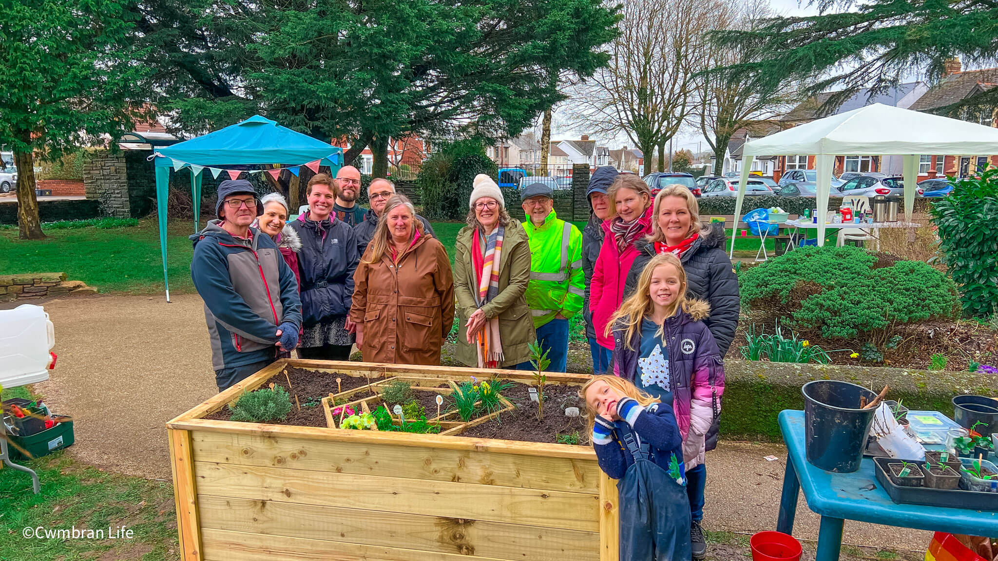 group of people stood by planter