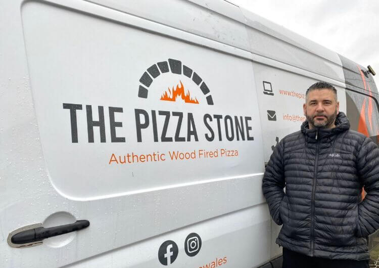a man stood by pizza van