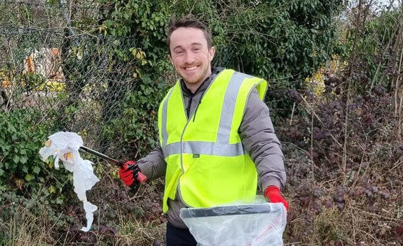 man holding a litter picker