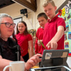 pupils shows a woman how to use an ipad