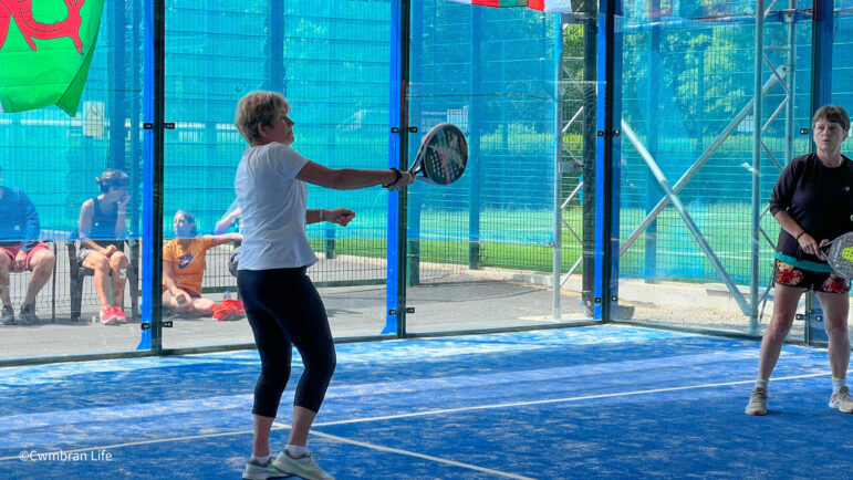 Two women play padel tennis