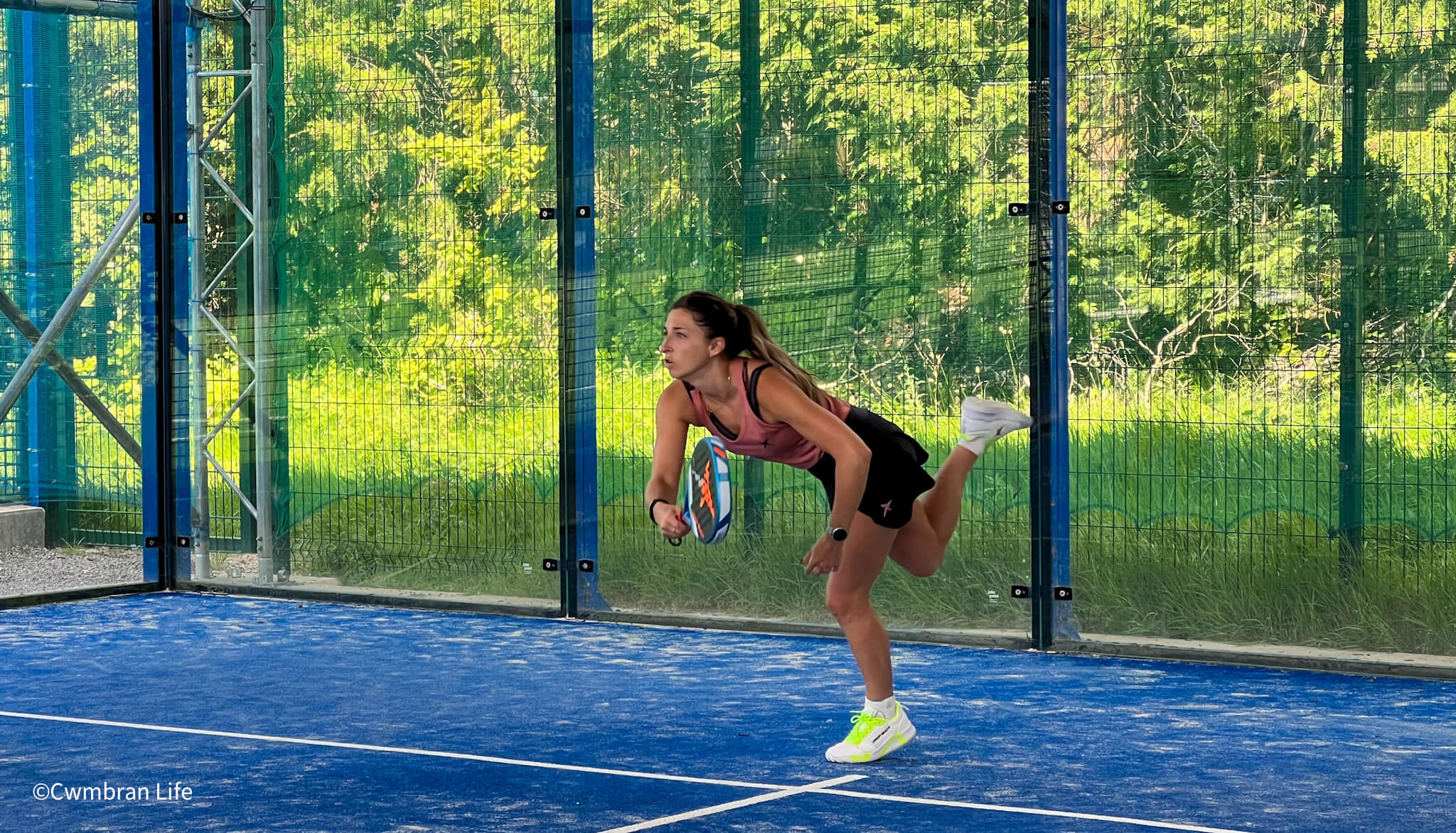 a woman playing padel