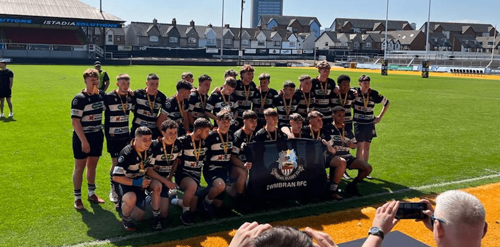 a rugby team celebrate winning a cup final