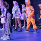 children dance on a stage