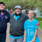 two men and a boy wearing headphones
