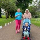 two women and a toddler in a pram