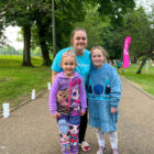 a woman and two young girls walking