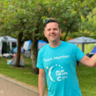 a man with raised fist smiles at camera
