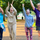 four women with headphones cheering