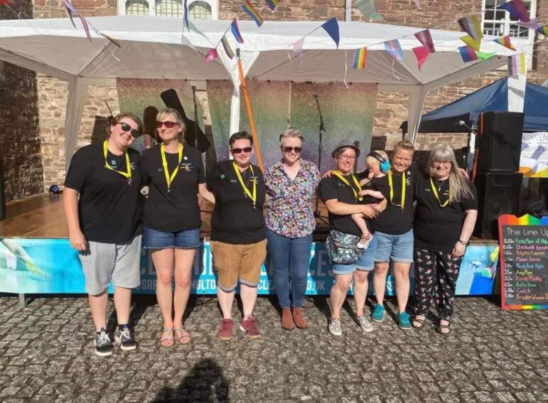 group of people stood in a row smiling