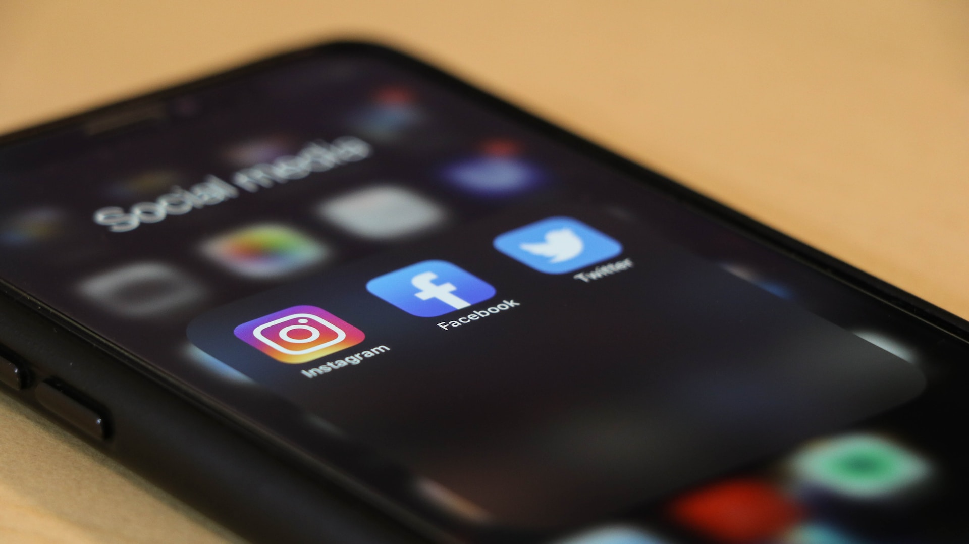 a mobile phone with social media apps on the screen