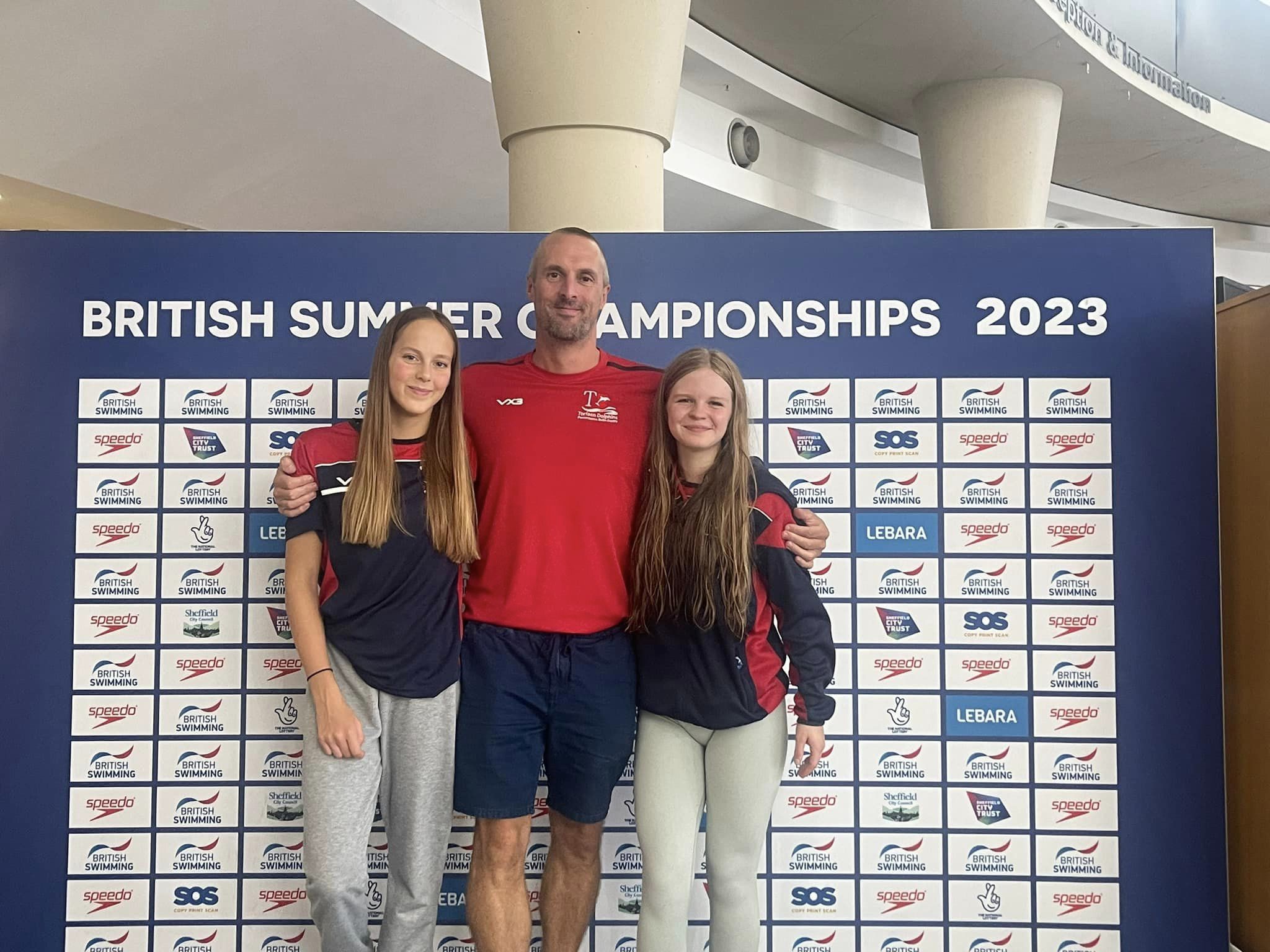 two swimmers and their coach