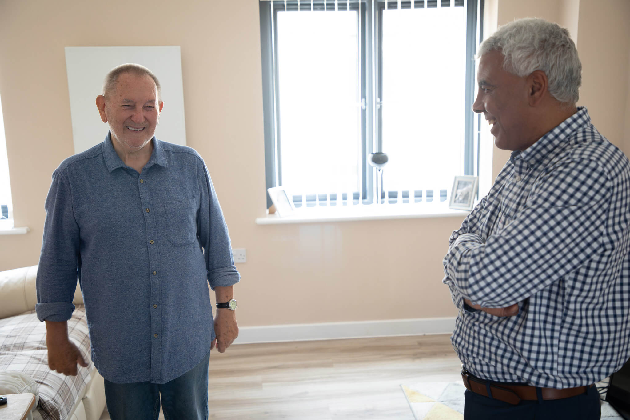 two men in flat laughing with each other