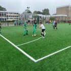 a junior football match on an all weather pitch