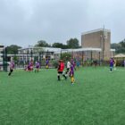 a junior football match on an all weather pitch