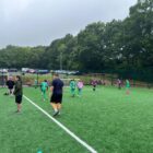 a junior football match on an all weather pitch
