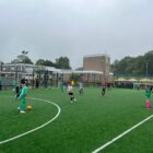 a junior football match on an all weather pitch