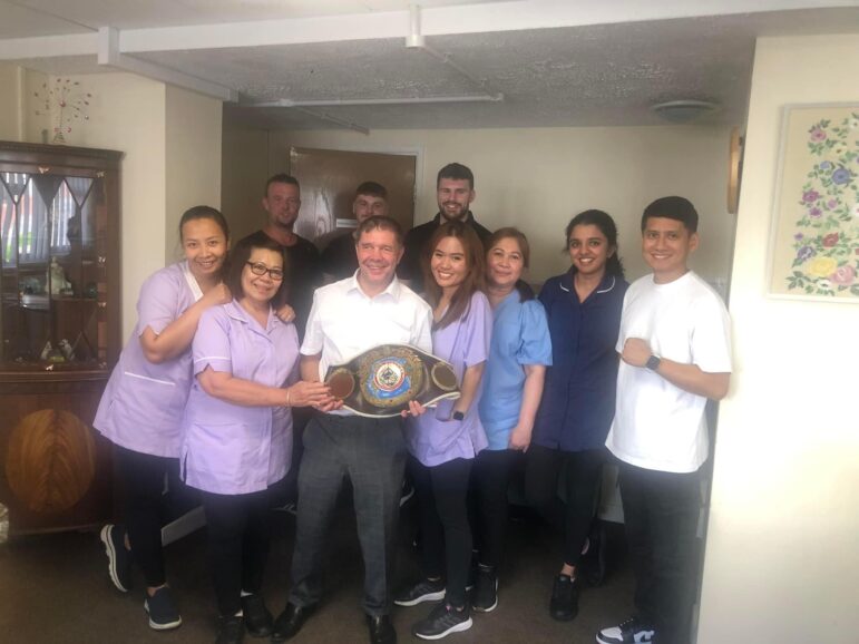 a group of care home staff with former boxing champ Robbie Regan