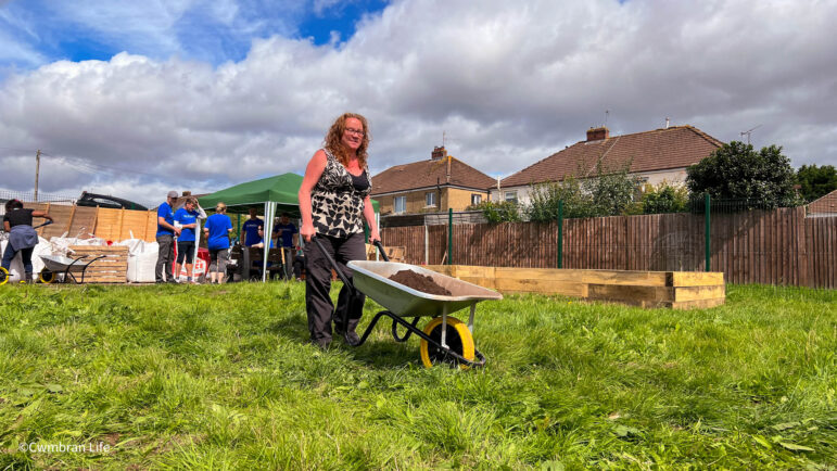 a woman pushes a wheelbarrow