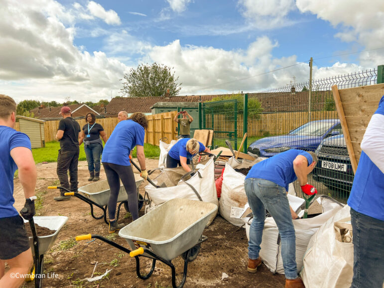 Volunteers fill up bags of soil