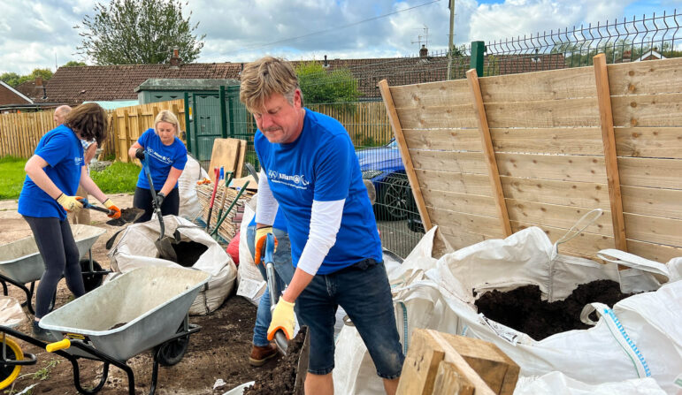 Volunteers fill up bags of soil