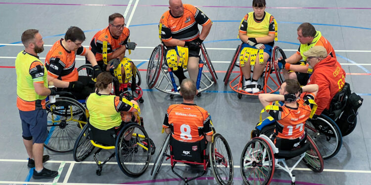 a wheelchair rugby league team have team talk