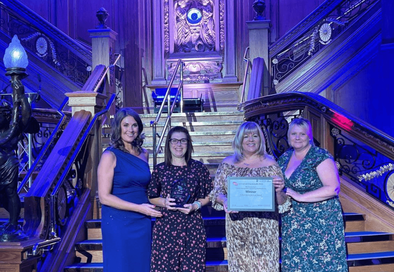 four women hold an award