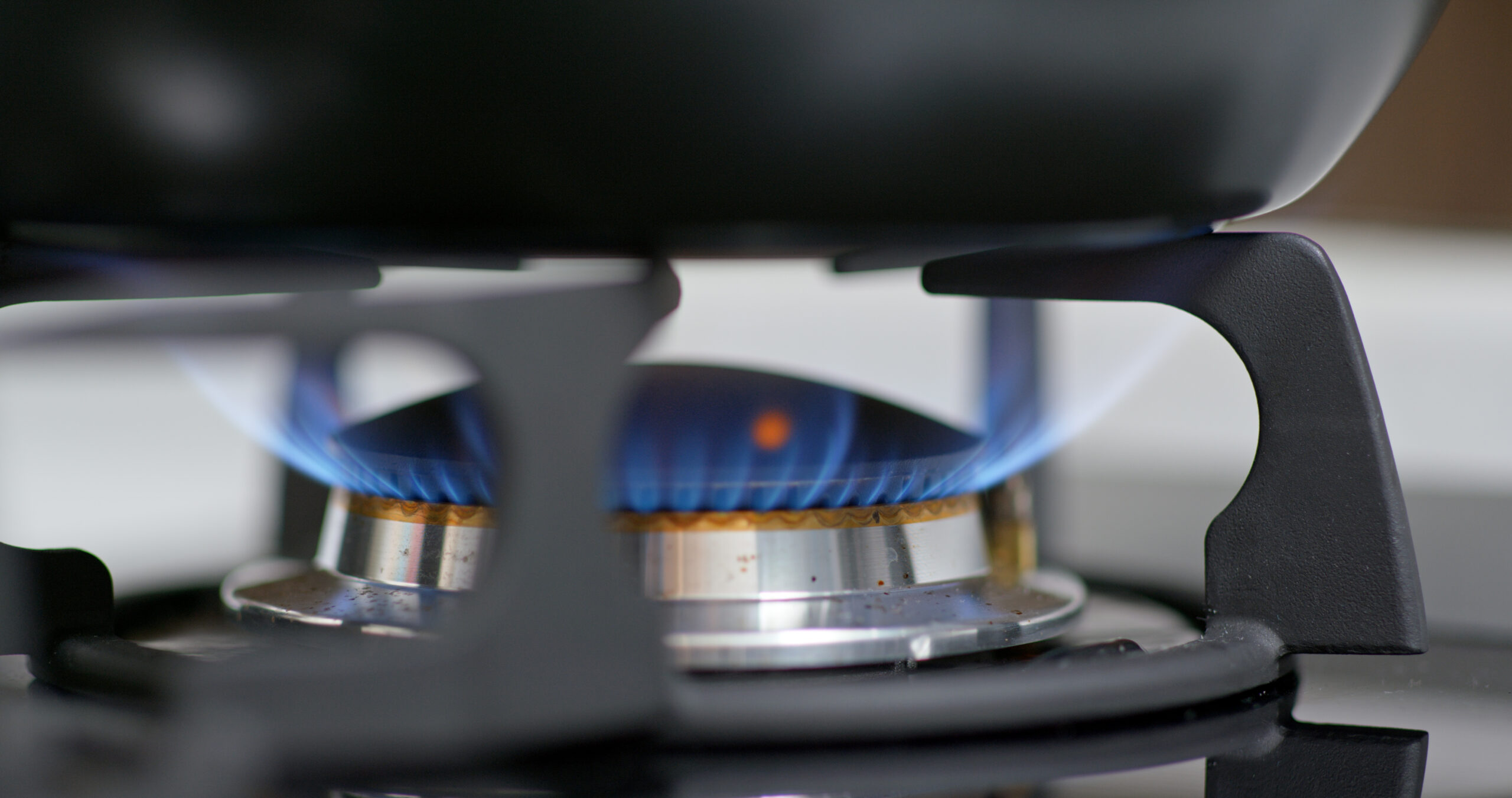 a gas stove flame under a pan