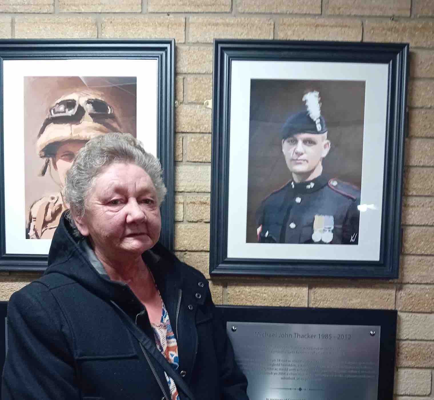 Alison Thacker by the portrait of her son