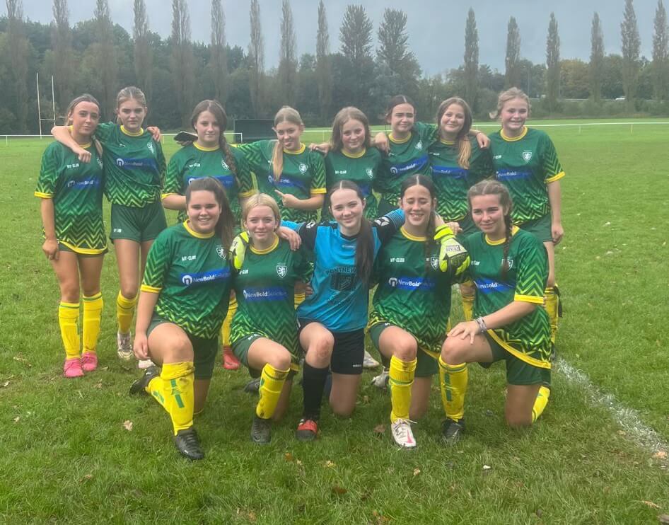a girls football team have a team photo