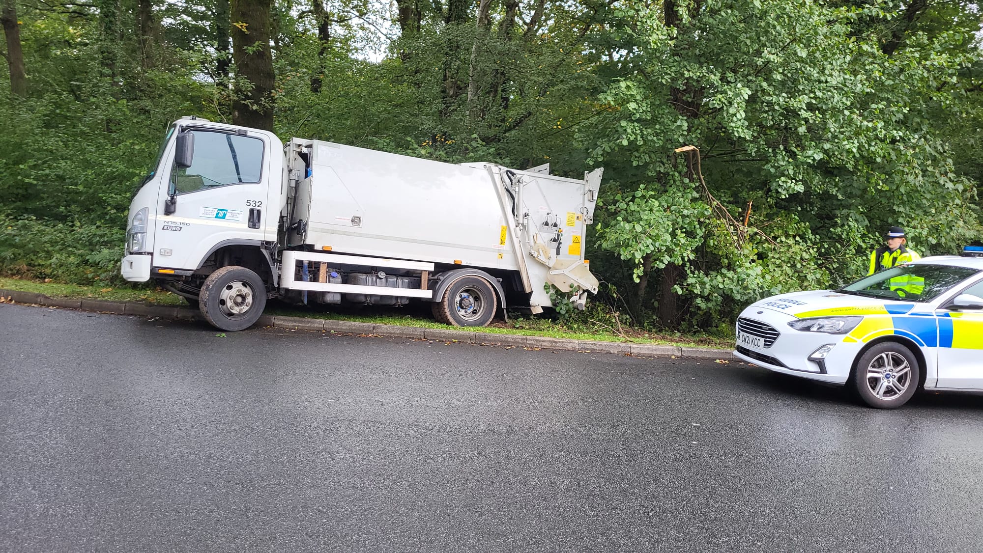 a refuse lorry parked on a roundabout