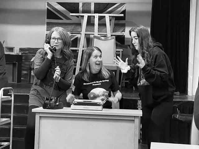 three actors on stage