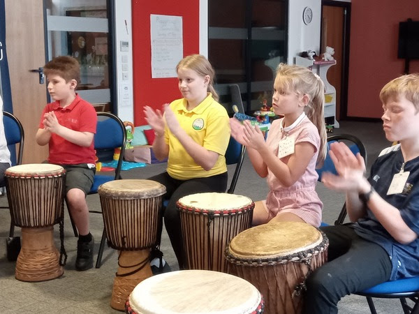 a group of children play instruments