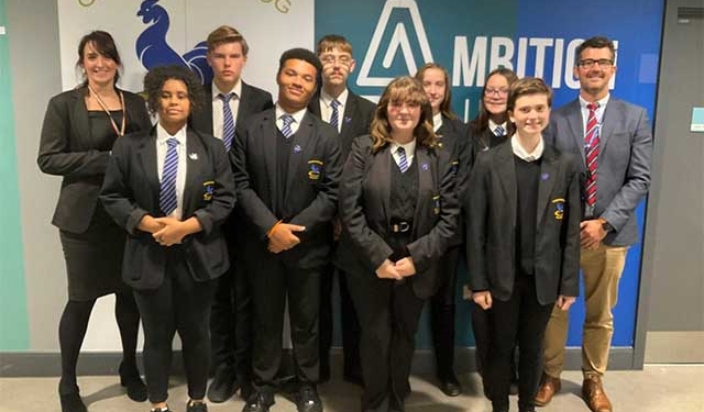 a group of pupils stood with two teachers