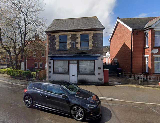 a house with a car driving past it