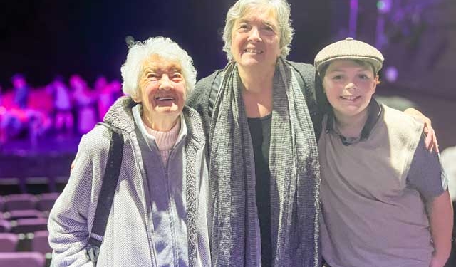 a boy with his grandmother and great-grandmother at a theatre